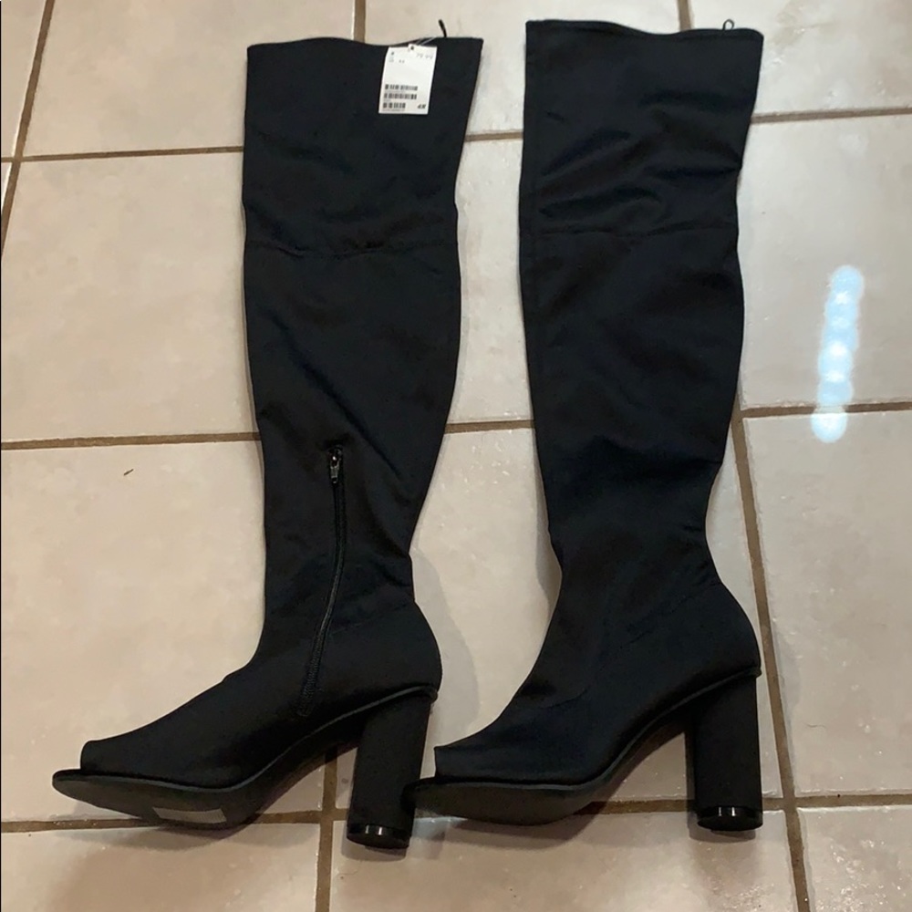 Thigh-High boots with peep toe.
